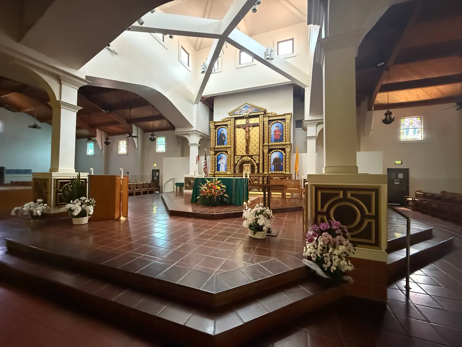 Raised sanctuary at Blessed Sacrament with white columns and arches, and dark panels with gold trim on the column pedestals