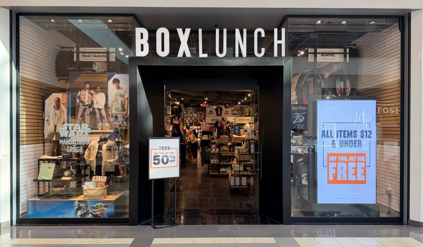 BoxLunch storefront: white BOXLUNCH letters over a black entry portal, flanked by glass display windows