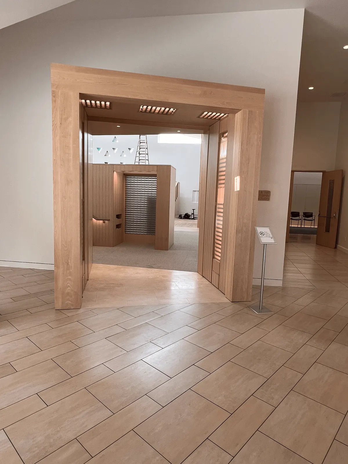 The Portal at Kehillat Israel seen from the lobby: a deep light-wood entry frame leading into the sanctuary