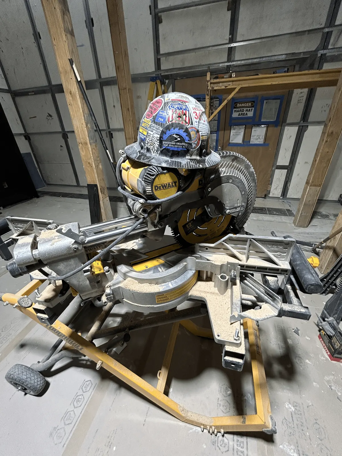 Precision Cabinets and Millwork hard hat on a sliding miter saw in the store during installation